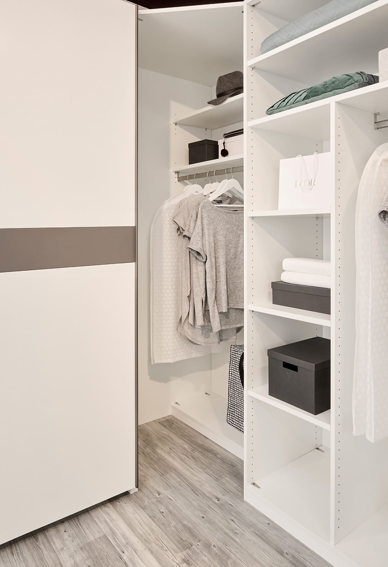 Nahaufnahme einer Ecklösung bzw. eines Eckkleiderschrankes ohne Türen und ohne Boden, damit der Zugang komfortabler ist